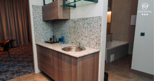 a bathroom with a sink and a bath tub at OTIA HOTEL in Maputo