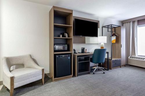 a hotel room with a desk and a chair and a computer at Comfort Inn Beckley in Beckley