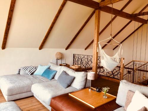 a living room with a couch and a hammock at Der Hof am Wald in Weichselbaum