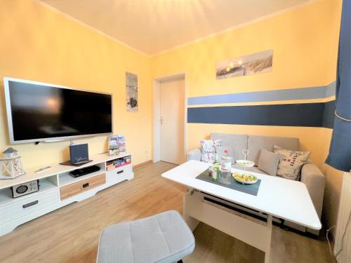 a living room with a large flat screen tv at Ferienwohnung Rabennest in Binz