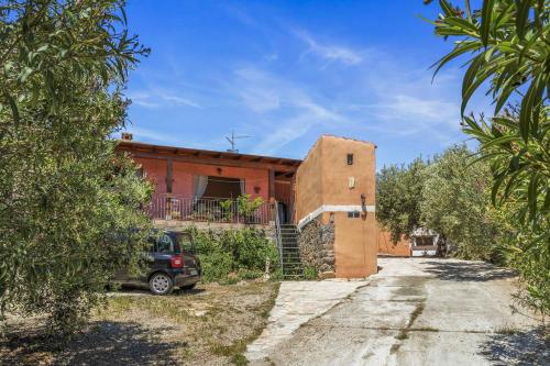 a house with a car parked in front of it at Villetta degli Oleandri in Solanas