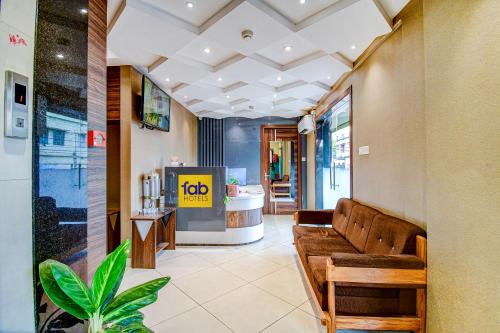 a lobby with a couch and a job counter at FabHotel Royal Crystal in Bhubaneshwar