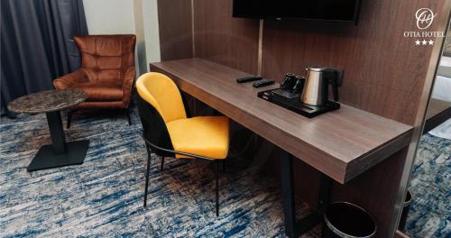 a hotel room with a desk and a chair at OTIA HOTEL in Maputo