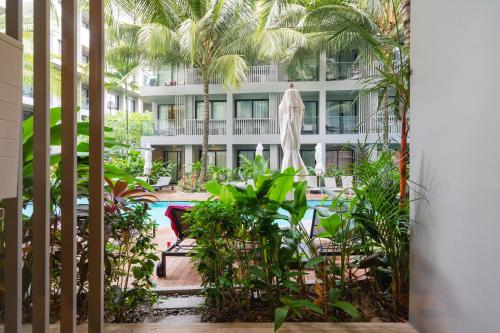 a view of a resort with a pool and palm trees at Pool Access Condo Bangtao Beach in Bang Tao Beach