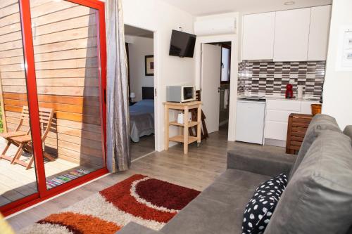 a living room with a couch and a kitchen at Casinhas do Minho in Arcos de Valdevez