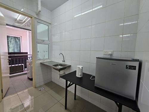 a kitchen with a counter and a sink in a room at De Centrum By Jom La Homestay, Kajang Bangi in Kajang