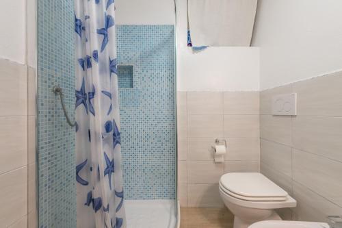 a bathroom with a toilet and a shower at Porto Luna in Villasimius