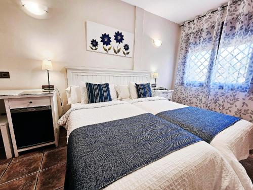 a bedroom with a large bed and a window at Hotel Medina de Toledo in Toledo