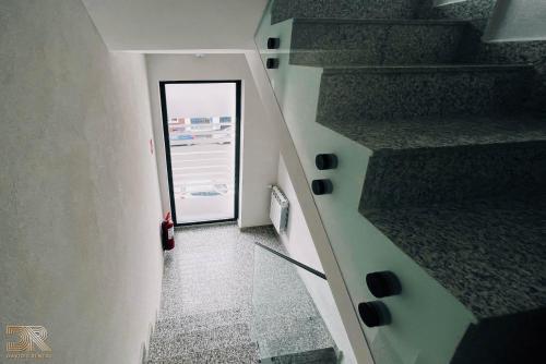 a hallway with a glass door and a stair case at DAVID'S RENTAL ROOMs in Bucharest