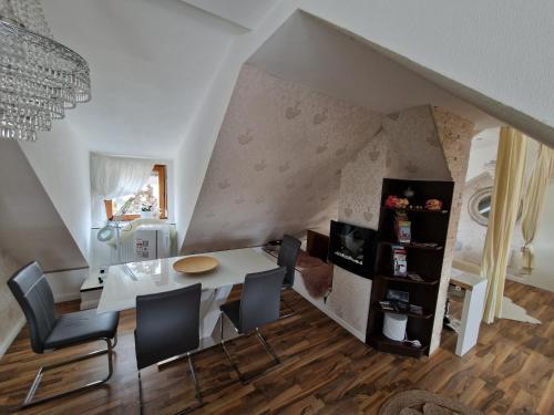 a dining room with a white table and chairs at Unterkunft Mitten im schönen Frankenland in Buchbrunn