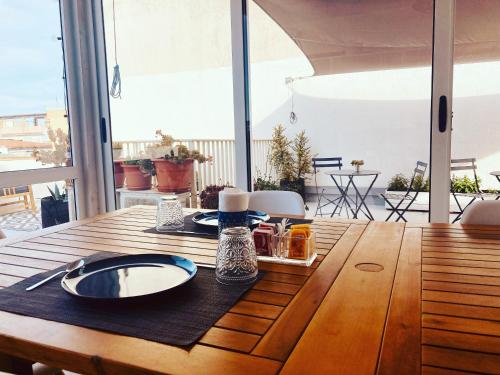 a wooden table with a plate of food on it at B&B CASA GILANIA LAMPEDUSA in Lampedusa