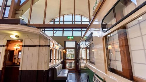 a train inside of a building with a hallway at Shokudo and Hotel Kisyapoppo in Nakatsu
