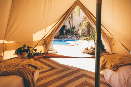 a tent with a view of a swimming pool at Slow Axarquía in Torre de Benagalbón