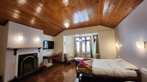 a bedroom with a bed and a fireplace at Ivanhoe Hotel (A Heritage Property) in Darjeeling