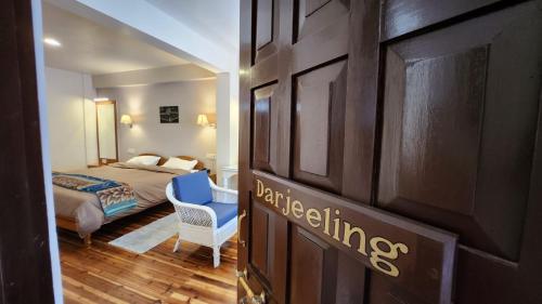 a room with a bedroom with a bed and a door at Ivanhoe Hotel (A Heritage Property) in Darjeeling