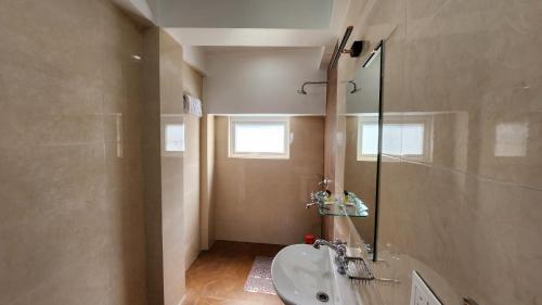 a bathroom with a sink and a mirror at Ivanhoe Hotel (A Heritage Property) in Darjeeling