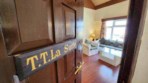a door to a room with a living room at Ivanhoe Hotel (A Heritage Property) in Darjeeling