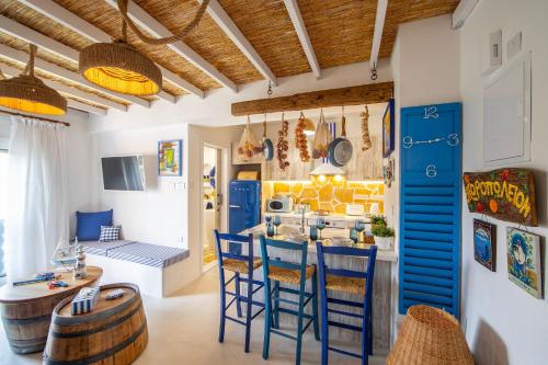 a kitchen with blue chairs and a table in a room at Castle Holiday Apartments in Limassol