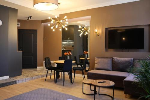a living room with a couch and a table at DK Premium Warmińska Secesja in Olsztyn