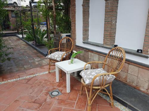 two chairs and a table with a bird sitting on it at Air Luxury in Terzigno