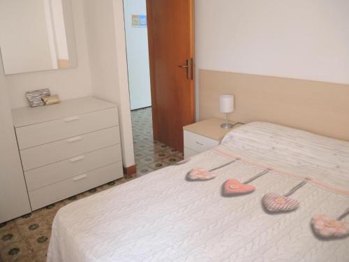 a bedroom with two hearts on a bed at Nice flat with terrace in a great spot - Beahost in Bibione