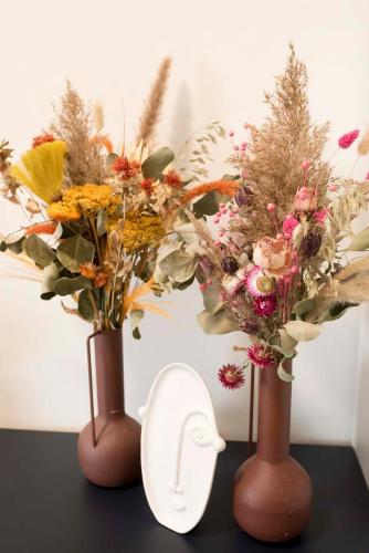 three vases with flowers in them on a table at MOVEEN! Wynajem apartamentów we Wrocławiu! 10 minut od centrum in Wrocław