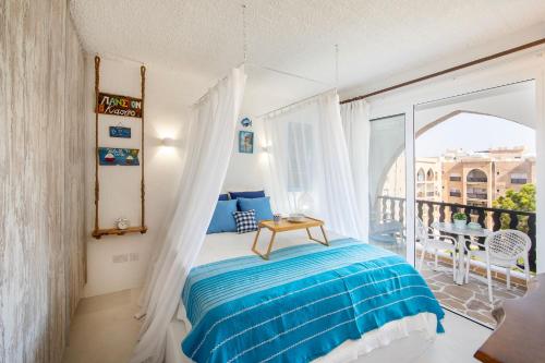 a bedroom with a bed and a balcony at Castle Holiday Apartments in Limassol