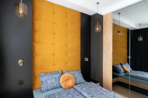 a bedroom with a bed and a large mirror at Golden Apartments Sokolska 30 Towers&74 in Katowice