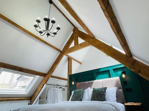 A bed or beds in a room at THE APPLE LOFT - Rustic luxury one bed cottage