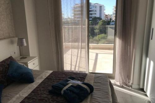 a bedroom with a bed and a large window at Green Hills 1-2 in Orihuela