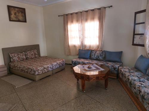 a living room with a couch and a coffee table at Studio Meknes Hamria in Meknès