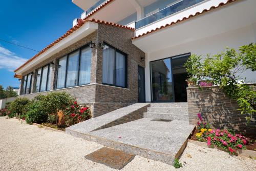 a house with a stone bench in front of it at Venti et Maris in Ksamil