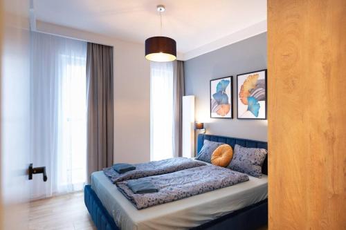 a bedroom with a bed in a room with a window at Golden Apartments Sokolska 30 Towers&59 in Katowice