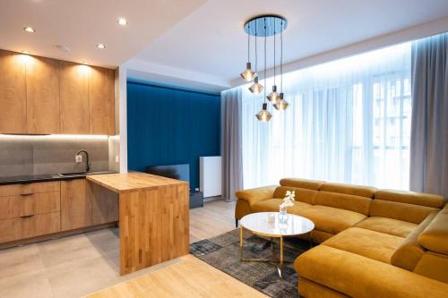a living room with a couch and a table at Golden Apartments Sokolska 30 Towers&59 in Katowice