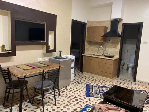 a kitchen with a table and chairs in a room at Madaba Mesha Stele Bedoiun Apartments in Madaba
