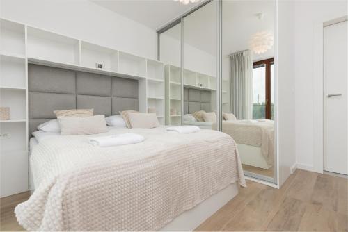 A bed or beds in a room at Okrzei 8 - Apartment with 2 balconies by Renters