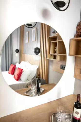 a room with a bed and a round mirror at Magdalena Suite 1,0 in Heraklio