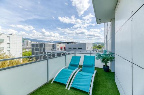 - un balcon avec deux chaises bleues dans un bâtiment dans l'établissement Le Bali- Garage- Terrasse- Relaxant- Belle Vue, à Grenoble