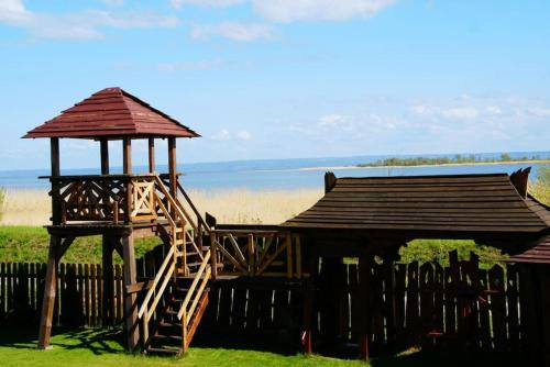 a wooden gazebo with a staircase and a tower at Zalewowo domki letniskowe in Kąty Rybackie