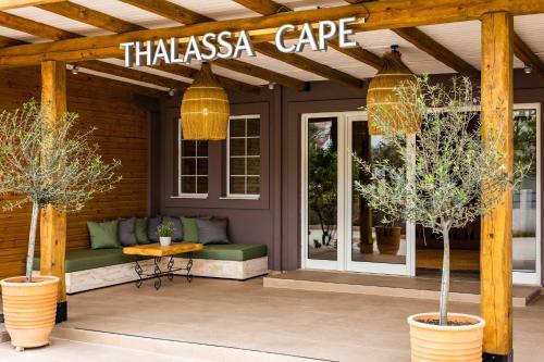 a patio with a sign that reads thiasasia cape at Skiathos Thalassa Cape Hotel, Philian Hotels and Resorts in Megali Ammos