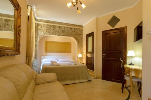 a bedroom with a bed and a couch at B&B Le Stanze di Ludovica in Termoli
