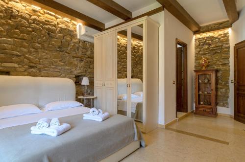 a bedroom with two beds and a stone wall at B&B Le Stanze di Ludovica in Termoli