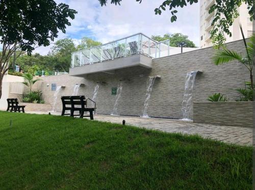 a building with a water fountain with a balcony at Park veredas Rio Quente Flavia in Rio Quente