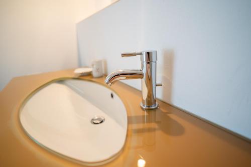 a sink in a bathroom with a faucet at Hus an de Marsch in Midlum