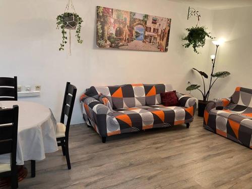 a living room with two couches and a table at Limor-resident in Qasrîne