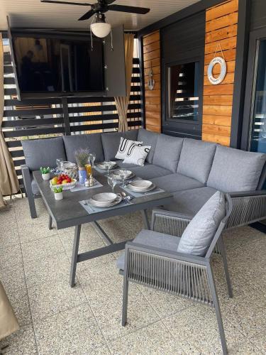 a couch and a table on a patio at ZB Mobile Homes in Privlaka