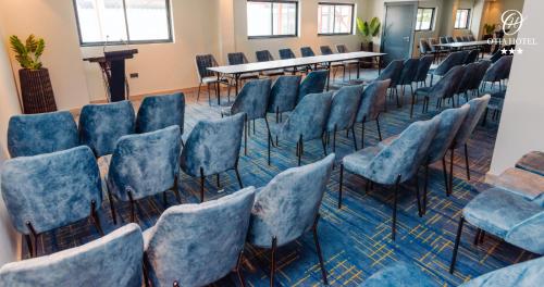 a room with a bunch of chairs and a table at OTIA HOTEL in Maputo