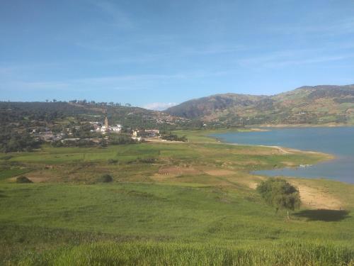 a view of a lake and a town on a hill at The beautiful view in Daher