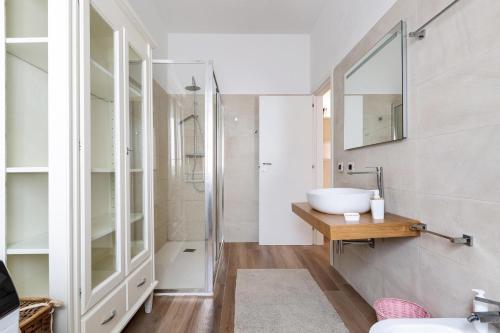 a bathroom with a sink and a mirror at Villa San Donato by BarbarHouse in San Donato