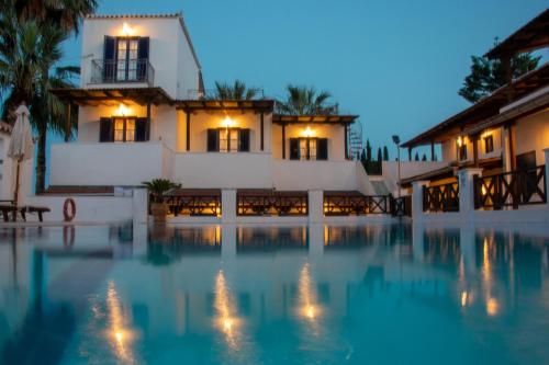 a villa with a swimming pool at night at 7 Islands in Spetses